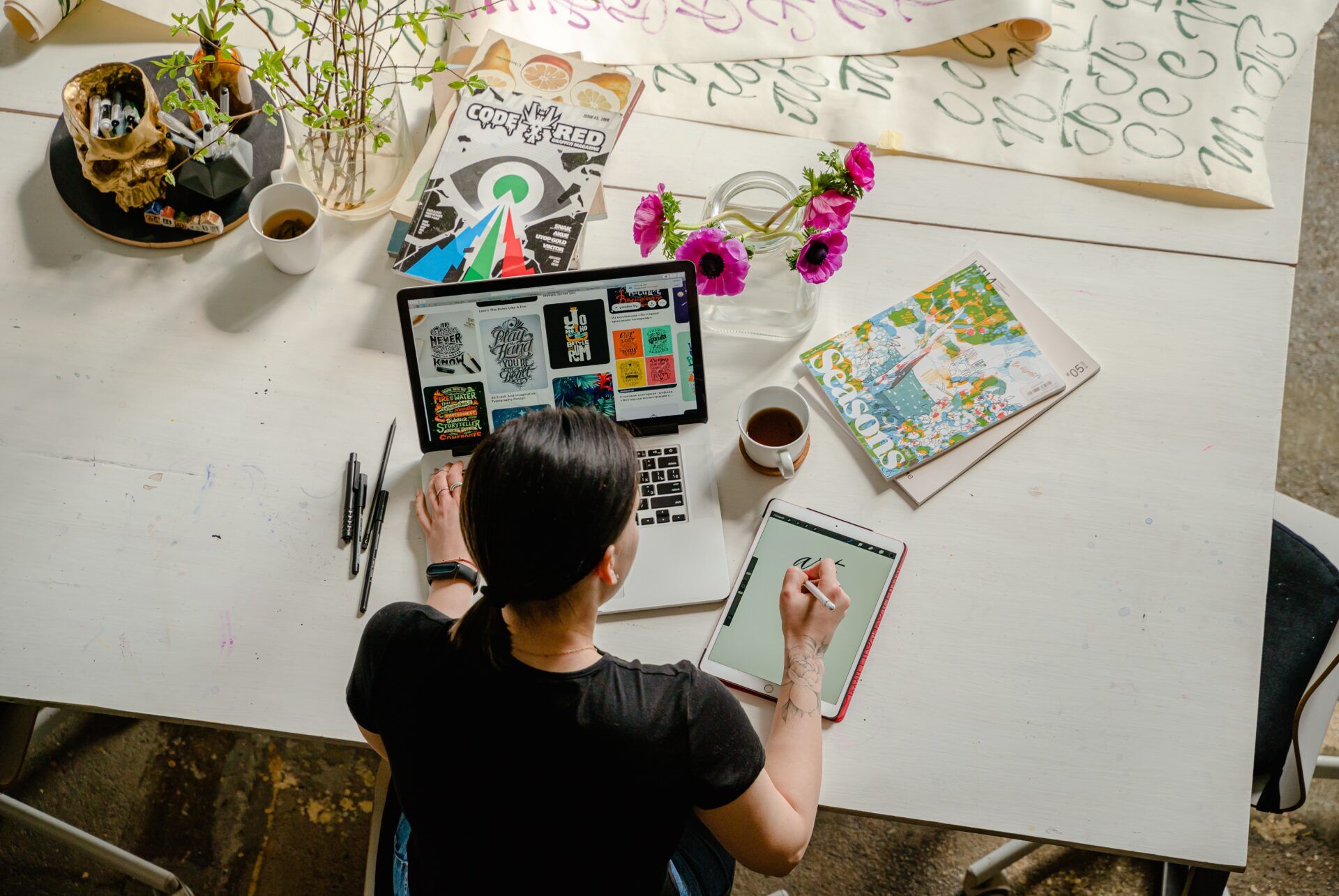 Graphic designer working on a design on her tablet.